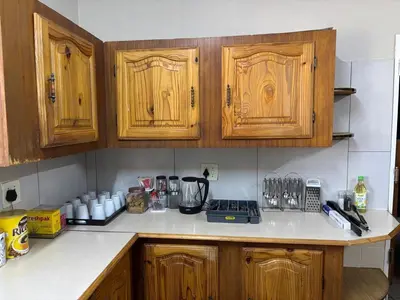 a kitchen with wooden cabinets and a counter top at The Bushveld Jasmine in Mokopane