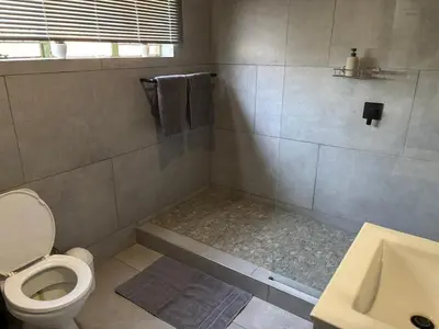a bathroom with a toilet and a sink at The Bushveld Jasmine in Mokopane