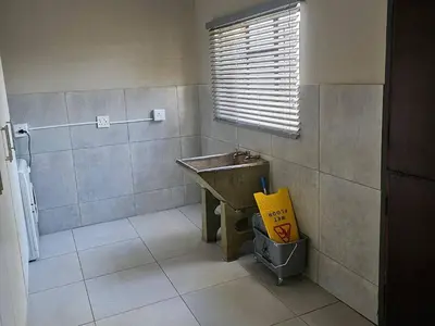 a bathroom with a sink and a window at The Bushveld Jasmine in Mokopane