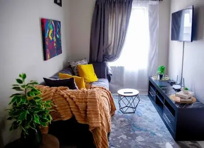 a living room with a couch and a window at Luxury on New in Midrand