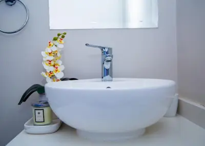a white sink with a faucet in a bathroom at Luxury on New in Midrand