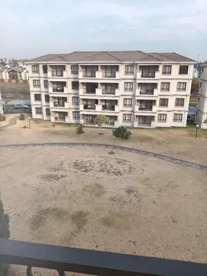 a large white apartment building with a large yard at Phoenix Living in Midrand