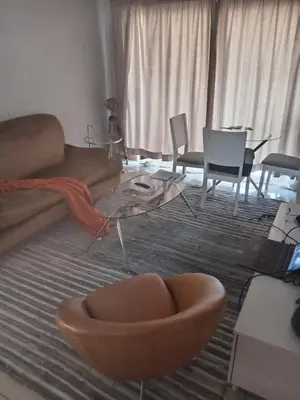 a living room with a couch and a table and chairs at Phoenix Living in Midrand