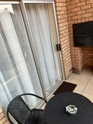 a table and a chair with a bowl on a table at Luxury Loft eMalahleni in Witbank