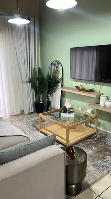 a living room with a couch and a glass table at Luxury Loft eMalahleni in Witbank