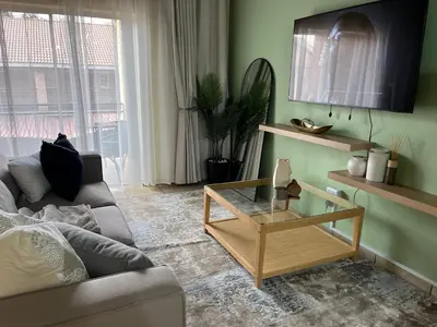 a living room with a couch and a coffee table at Luxury Loft eMalahleni in Witbank