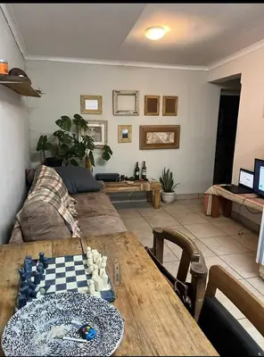 a living room with a table and a couch at Jenkins Stay in Pretoria