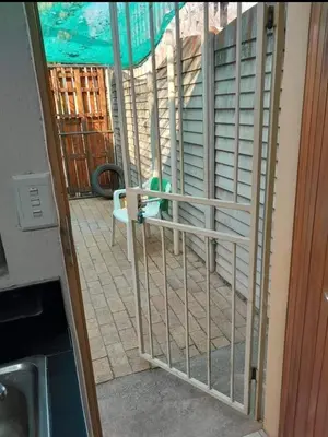 a view of a screened in porch with a gate at Jenkins Stay in Pretoria