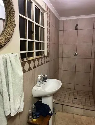 a bathroom with a sink and a shower at Jenkins Stay in Pretoria