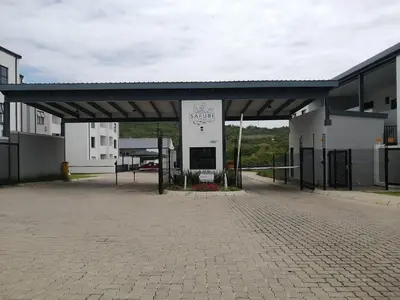 a parking lot with a large building with acheck out my city sign at Luna Luxury Living in Nelspruit