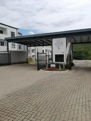 a parking lot with a building with a sign on it at Luna Luxury Living in Nelspruit