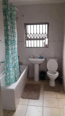a bathroom with a toilet and a tub and a sink at Home away from home in Polokwane