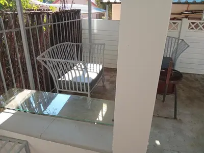 a patio with two chairs and a glass table at Laetari Guest House in Hartbeespoort