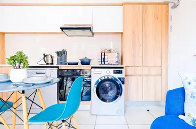 a kitchen with a washing machine and a table and chairs at Navy Lagoon Stay The Blyde in Pretoria