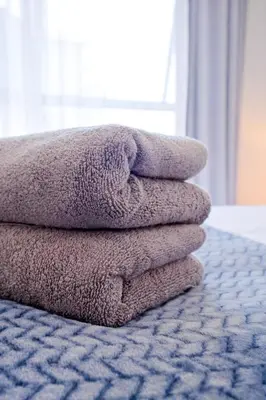 a pile of towels sitting on top of a bed at Navy Lagoon Stay The Blyde in Pretoria