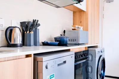a kitchen with a washer and dryer on a counter at Navy Lagoon Stay The Blyde in Pretoria