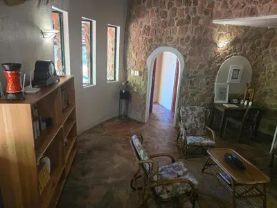 a living room with a table and chairs in a building at Tintshaba Safaris in Phalaborwa
