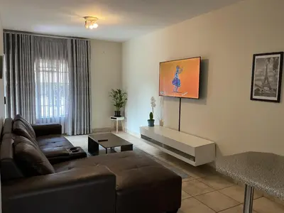 a living room with a couch and a table at Luxstay in Nelspruit