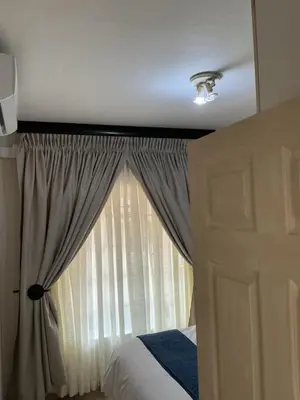 a bedroom with a bed and a window at Luxstay in Nelspruit