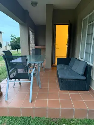 a patio with a couch and a table and chairs at Luxstay in Nelspruit