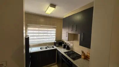 a small kitchen with a sink and a window at Luxstay in Nelspruit