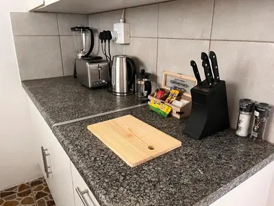 a kitchen counter with a cutting board and a blender at Private Garden Home Fast WiFi in Centurion
