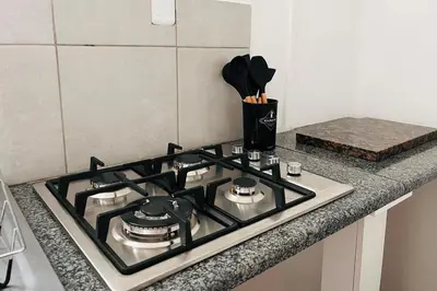 a stove top oven sitting on top of a kitchen counter at Private Garden Home Fast WiFi in Centurion