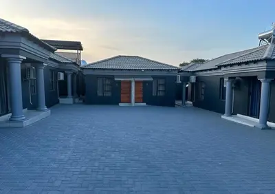 a row of blue houses with a driveway at Nyakhosi Luxury Guesthouse in Thohoyandou
