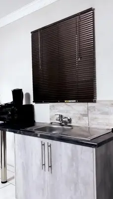 a kitchen with a sink and a window at Nyakhosi Luxury Guesthouse in Thohoyandou