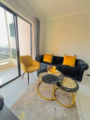 a living room with a couch and a table at Blyde Lagoon in Pretoria