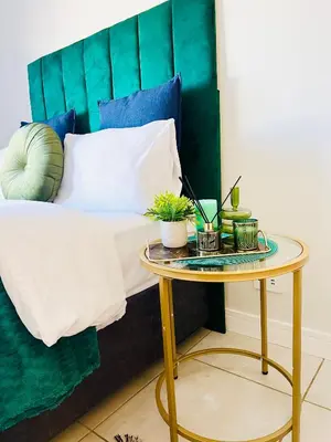 a table with plants on it next to a bed at Blyde Lagoon in Pretoria
