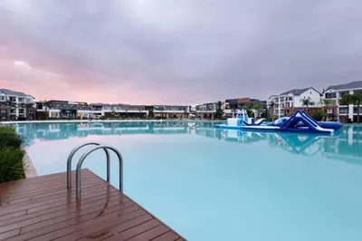 a large swimming pool with a blue pool raft at Blyde Lagoon in Pretoria