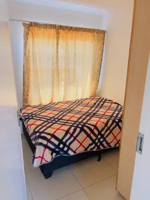 a small bed in a room with a window at Private Suite in Polokwane