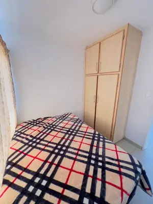 a bedroom with a bed and a cabinet at Private Suite in Polokwane