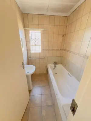 a bathroom with a tub and a sink at Private Suite in Polokwane
