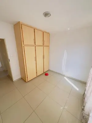 an empty room with cabinets and a tile floor at Private Suite in Polokwane