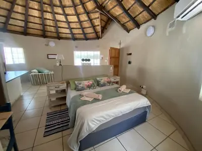 a bedroom with a large bed in a room at Kettie&Klip Self Catering Accommodation in Marloth Park