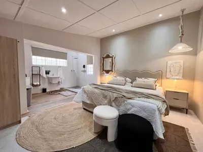 a bedroom with a large bed and a rug at Whispering Thorns Off-Site Apartment in White River