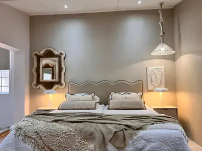 a bedroom with a large bed and a mirror at Whispering Thorns Off-Site Apartment in White River