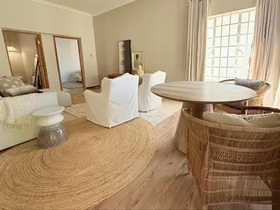 a living room with a table and chairs at Whispering Thorns Off-Site Apartment in White River