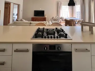 a kitchen with a stove top oven in a kitchen at Whispering Thorns Off-Site Apartment in White River