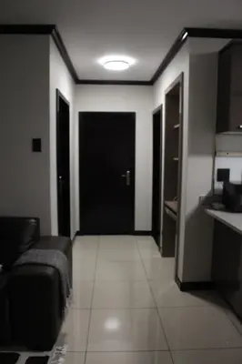 a living room with a couch and a black door at Blue Lake Estate Home in Midrand