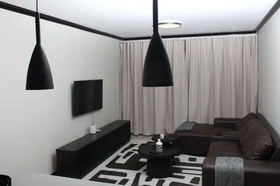 a living room with a couch and a tv at Blue Lake Estate Home in Midrand