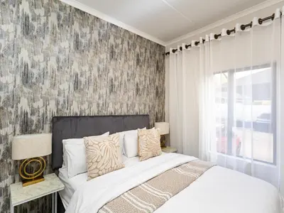 a bedroom with a bed and a wall mural at Reece Luxury Midrand Suite in Midrand