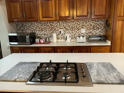 a kitchen with a stove top in a kitchen at Tranquil view lodge in Haenertsburg