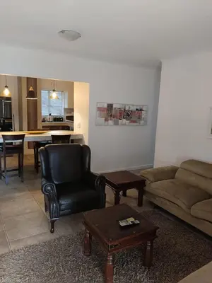 a living room with a couch and a chair and a table at Zamabhele Properties in Nelspruit