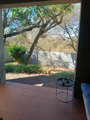 an open door to a patio with a table at Zamabhele Properties in Nelspruit