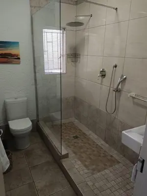 a bathroom with a shower and a toilet at Zamabhele Properties in Nelspruit