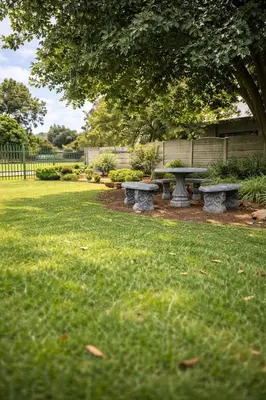 two picnic tables in the grass under a tree at Meadway on the parks in Benoni