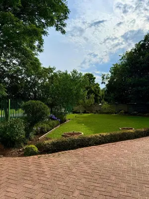 a garden with a brick walkway in a park at Cosy retreat for 2 at MeadWay in Benoni